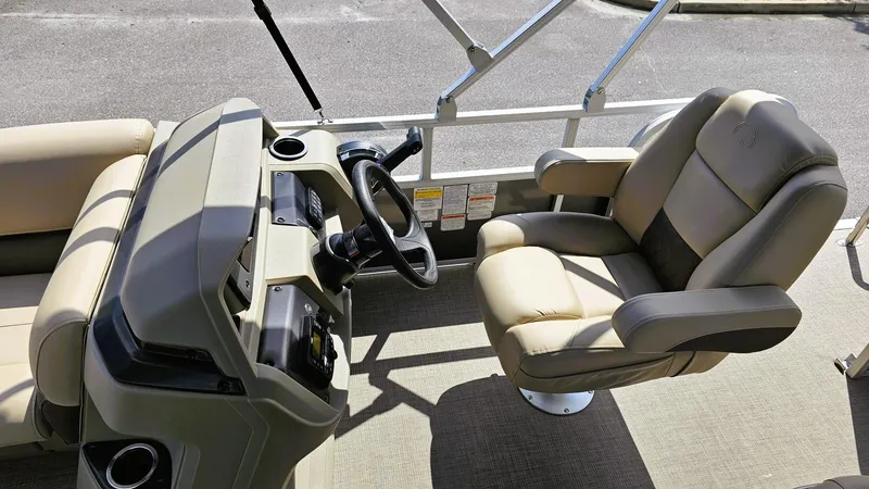 Slide: The Image of 2025 Sun Tracker Party Barge 18 DLX interior with steering console and comfortable seating. - 10