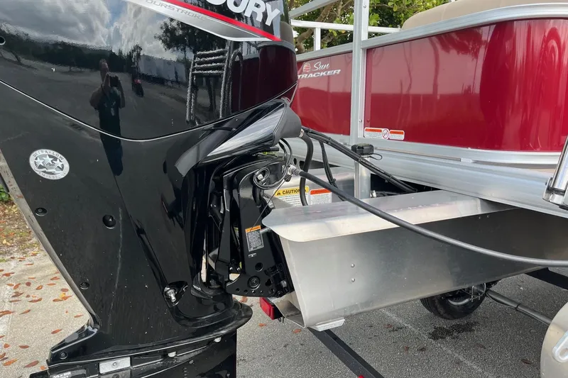 Slide: The Image of 2025 Sun Tracker Party Barge 18 DLX with Mercury outboard motor, side view. - 18
