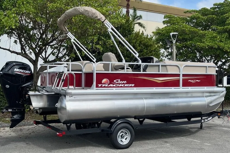 Slide: The Image of 2025 Sun Tracker Party Barge 18 DLX pontoon boat with Mercury engine on trailer. - 4