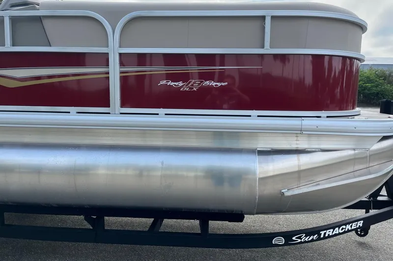 Slide: The Image of 2025 Sun Tracker Party Barge 18 DLX pontoon boat with red and silver design. - 5