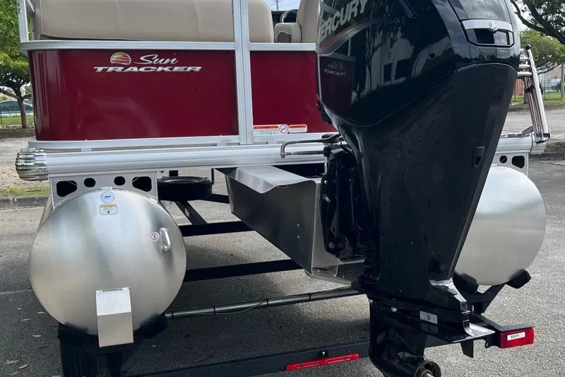 Slide: The Image of 2025 Sun Tracker Party Barge 18 DLX with Mercury outboard motor, rear view. - 6