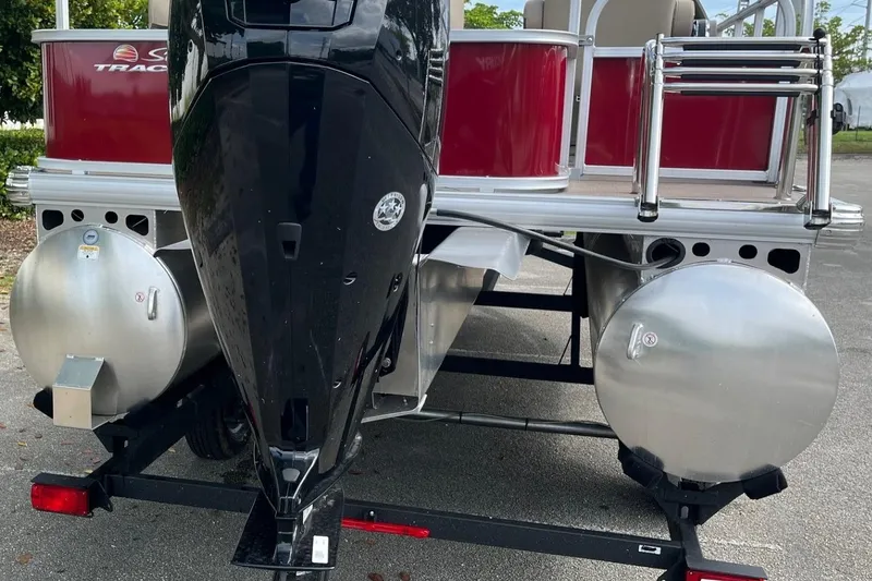 Slide: The Image of 2025 Sun Tracker Party Barge 18 DLX pontoon boat rear view with motor and pontoons. - 70