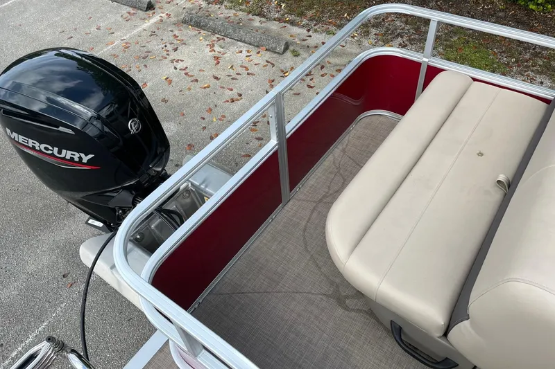 Slide: The Image of 2025 Sun Tracker Party Barge 18 DLX with Mercury outboard motor and beige seating. - 71