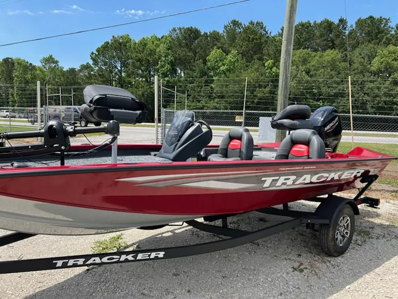 Slide: The Image of 2025 Tracker Pro Team 175 boat in red, parked on a trailer, outdoors. - 3