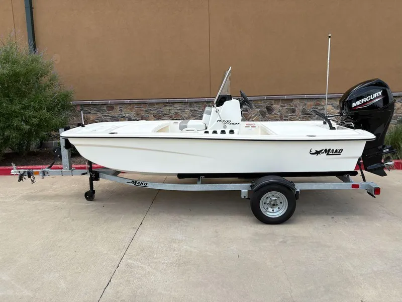 Slide: The Image of 2024 Mako Pro Skiff 13 CC boat on trailer, parked outdoors. - 0