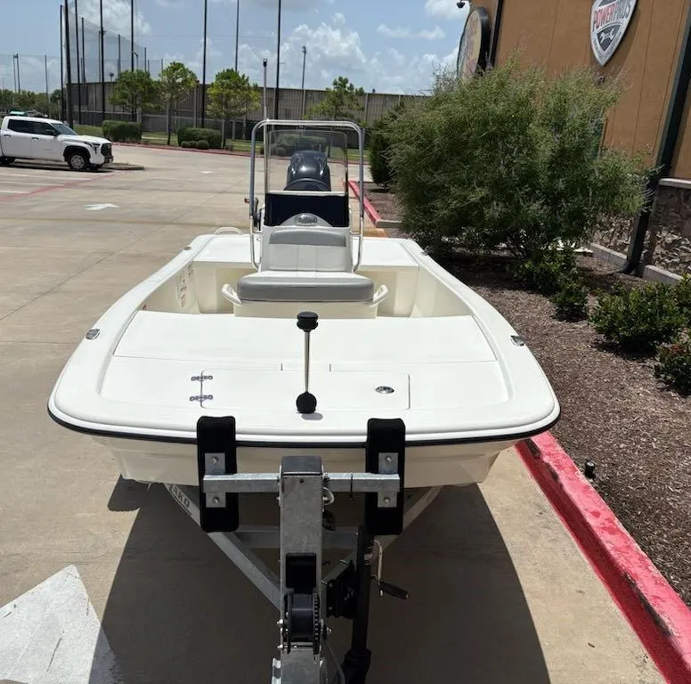 Slide: The Image of 2024 Mako Pro Skiff 13 CC boat on trailer in parking lot. - 1