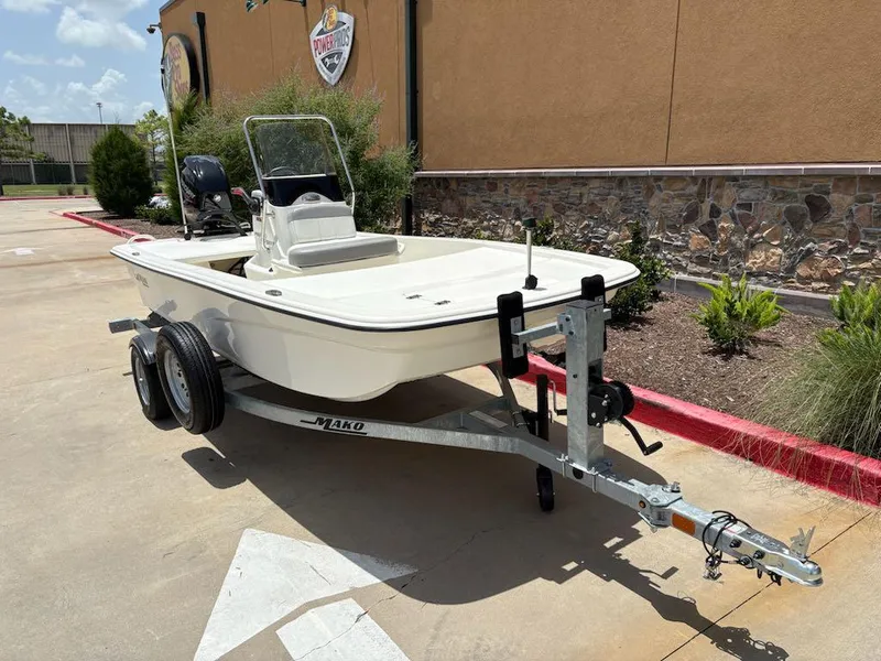 Slide: The Image of 2024 Mako Pro Skiff 13 CC boat on trailer, parked outdoors. - 2