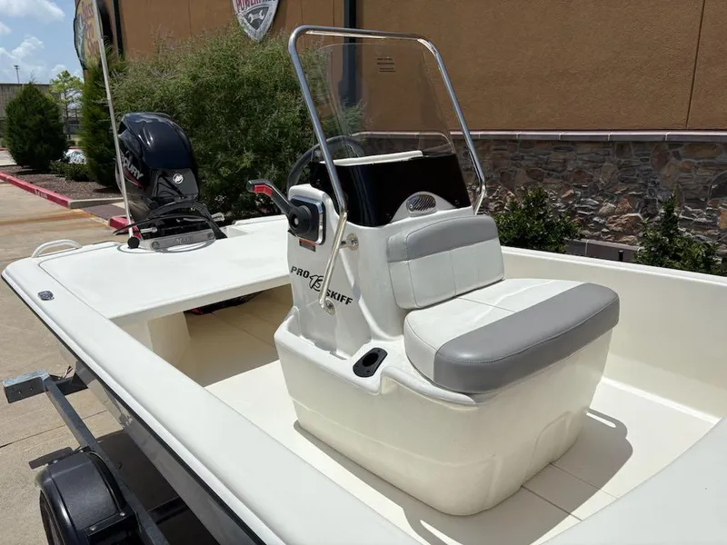 Slide: The Image of 2024 Mako Pro Skiff 13 CC boat with center console and outboard motor. - 4