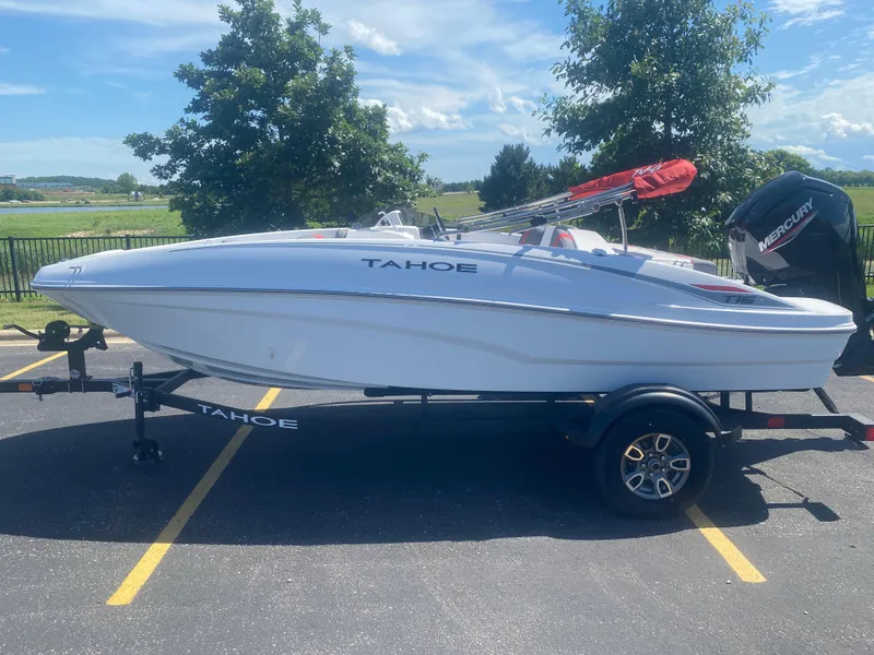 The Image of 2025 Tahoe T16 boat on trailer, parked outdoors under clear sky. - 0