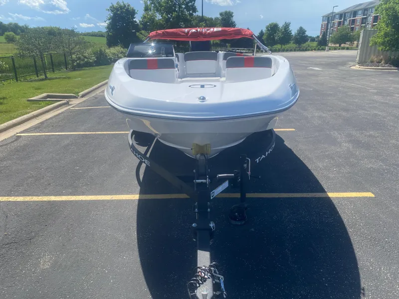 Slide: The Image of 2025 Tahoe T16 boat on trailer in sunny parking lot. - 2