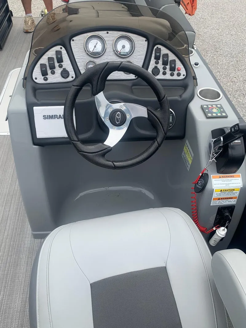 Slide: The Image of 2019 Veranda Relax VR25RC boat dashboard with steering wheel and control panel. - 20