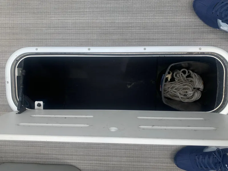 Slide: The Image of 2019 Veranda Relax VR25RC pontoon boat with Yamaha outboard motor, parked on gravel. - 6