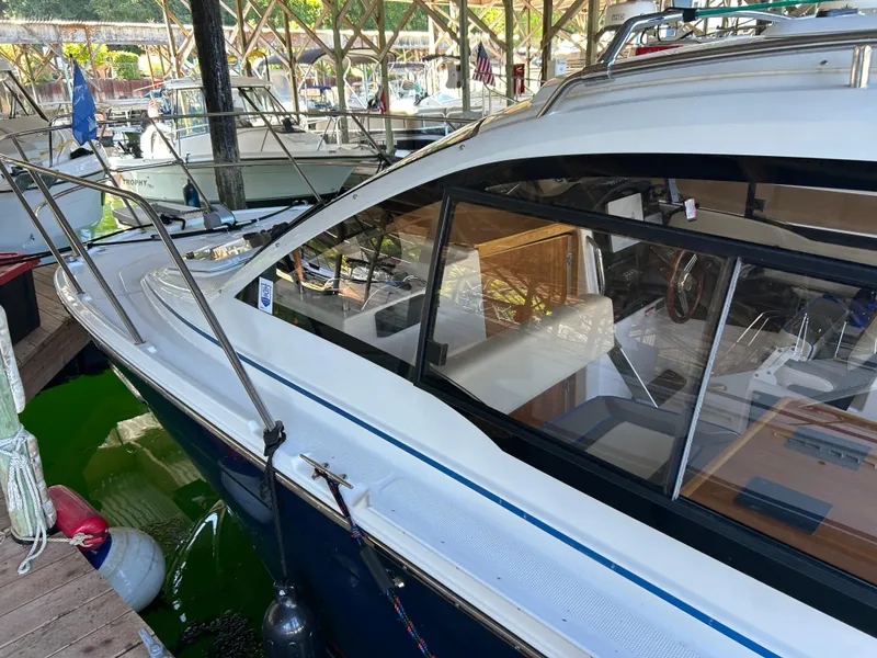 Slide: The Image of 2017 Cutwater C-242 Coupe docked in a marina, showcasing sleek design and spacious interior. - 11