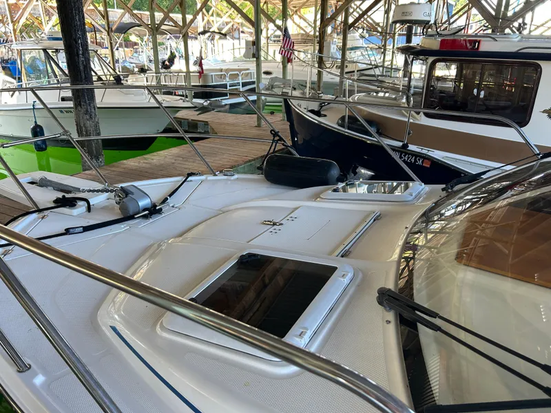 Slide: The Image of 2017 Cutwater C-242 Coupe docked in a marina, surrounded by other boats. - 16