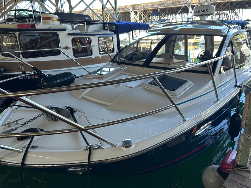 Slide: The Image of 2017 Cutwater C-242 Coupe boat docked in a marina, featuring sleek design and modern amenities. - 17