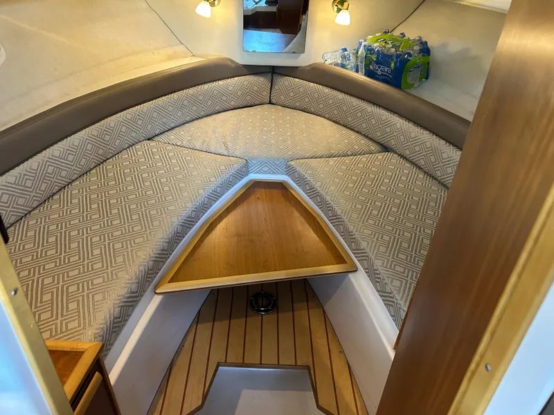 Slide: The Image of 2017 Cutwater C-242 Coupe interior cabin with cozy seating and wooden accents. - 3