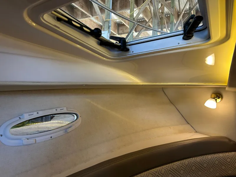 Slide: The Image of Interior view of 2017 Cutwater C-242 Coupe boat, featuring a window and ceiling light. - 5