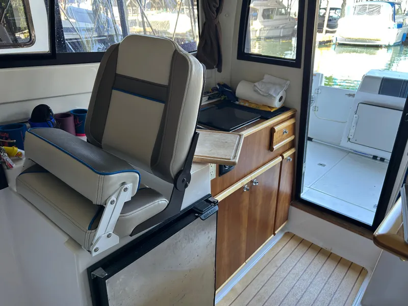 Slide: The Image of Interior of 2017 Cutwater C-242 Coupe boat with seating and kitchenette. - 7