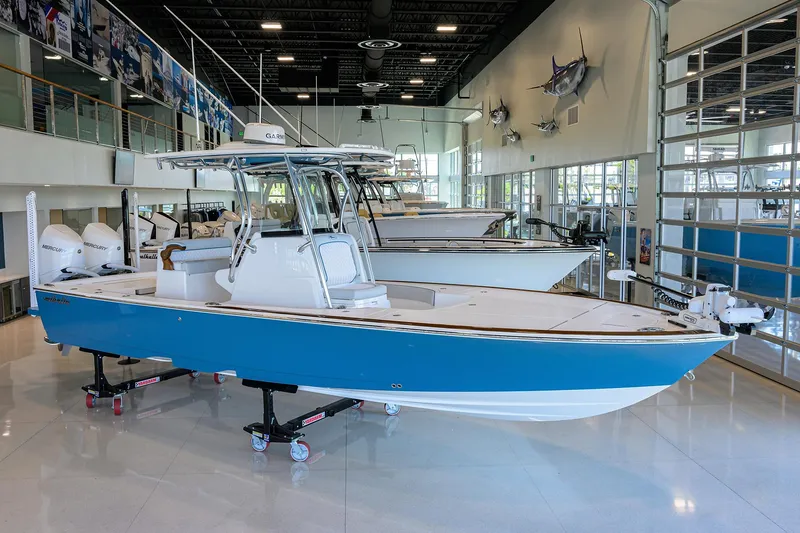 Slide: The Image of 2026 Valhalla Boatworks V-28 in showroom, blue hull, modern design, indoor display. - 3