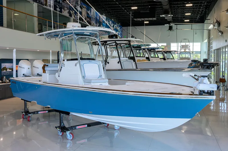 Slide: The Image of 2026 Valhalla Boatworks V-28 in showroom, featuring sleek blue and white design. - 4