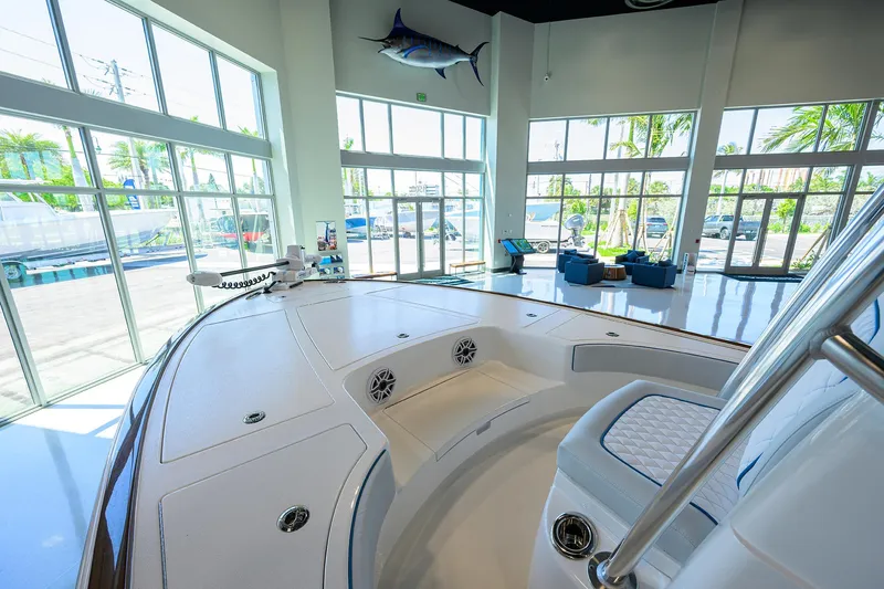 Slide: The Image of 2026 Valhalla Boatworks V-28 in showroom with large windows and palm trees outside. - 6