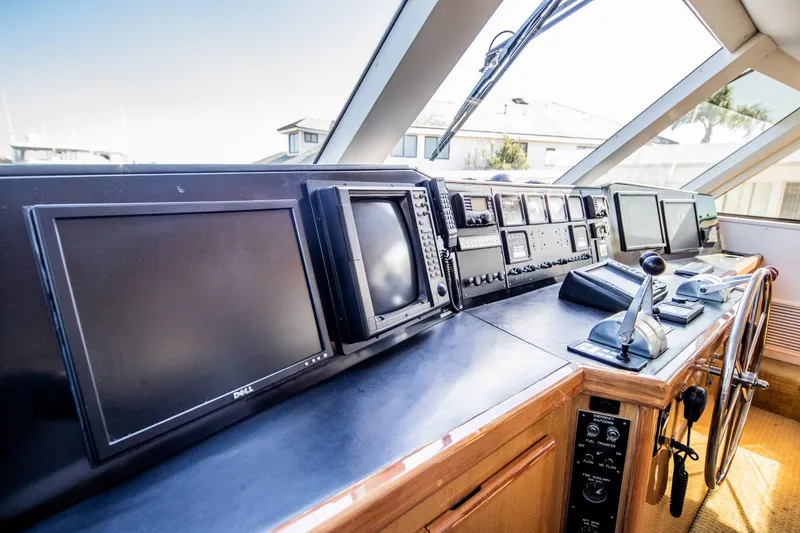 Slide: The Image of Control panel of a 1999 Viking 58 Enclosed Bridge yacht with navigation equipment. - 11