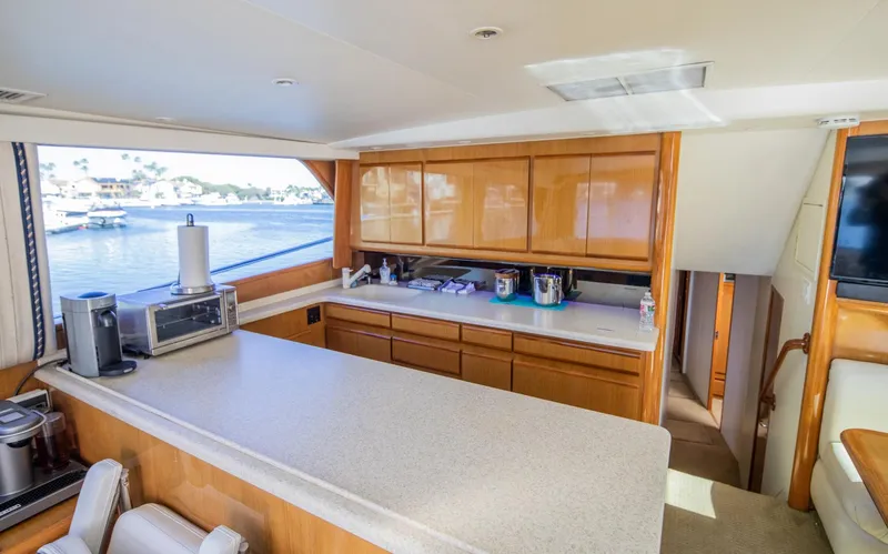 Slide: The Image of Interior of 1999 Viking 58 Enclosed Bridge yacht with modern kitchen amenities. - 13