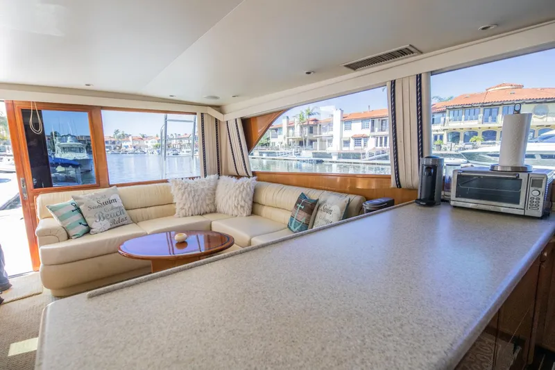 Slide: The Image of Luxurious interior of 1999 Viking 58 Enclosed Bridge yacht with waterfront view. - 15