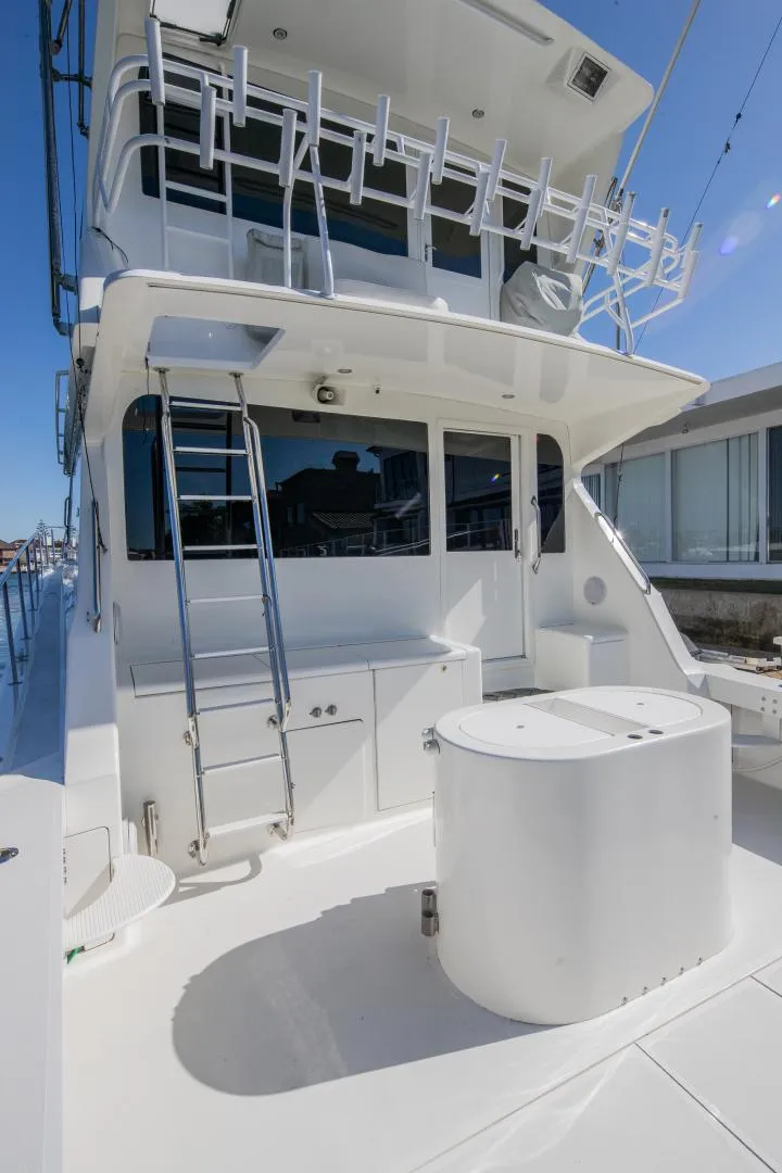 Slide: The Image of 1999 Viking 58 Enclosed Bridge yacht with spacious deck and ladder. - 24