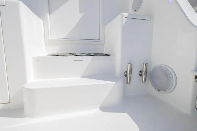Slide: The Image of White interior of 1999 Viking 58 Enclosed Bridge yacht, featuring steps and storage compartments. - 25