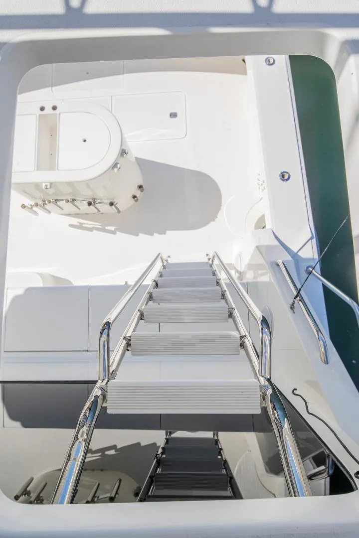 Slide: The Image of Staircase on 1999 Viking 58 Enclosed Bridge yacht, leading to a spacious deck area. - 26