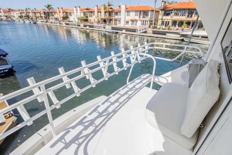 Slide: The Image of 1999 Viking 58 Enclosed Bridge yacht with waterfront view and luxurious seating. - 27