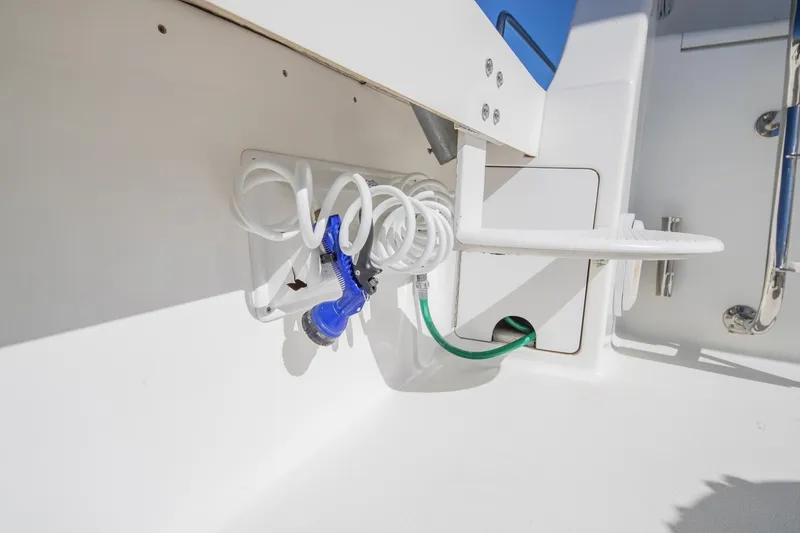 Slide: The Image of Coiled hose and nozzle on 1999 Viking 58 Enclosed Bridge yacht deck. - 29