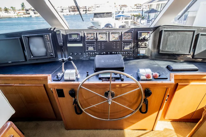 Slide: The Image of Cockpit of 1999 Viking 58 Enclosed Bridge yacht with steering wheel and navigation equipment. - 3