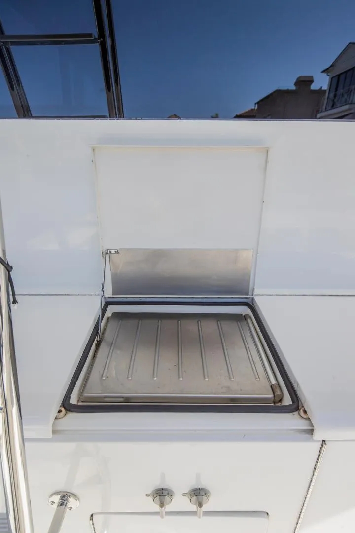 Slide: The Image of 1999 Viking 58 Enclosed Bridge yacht hatch, open with clear sky background. - 31