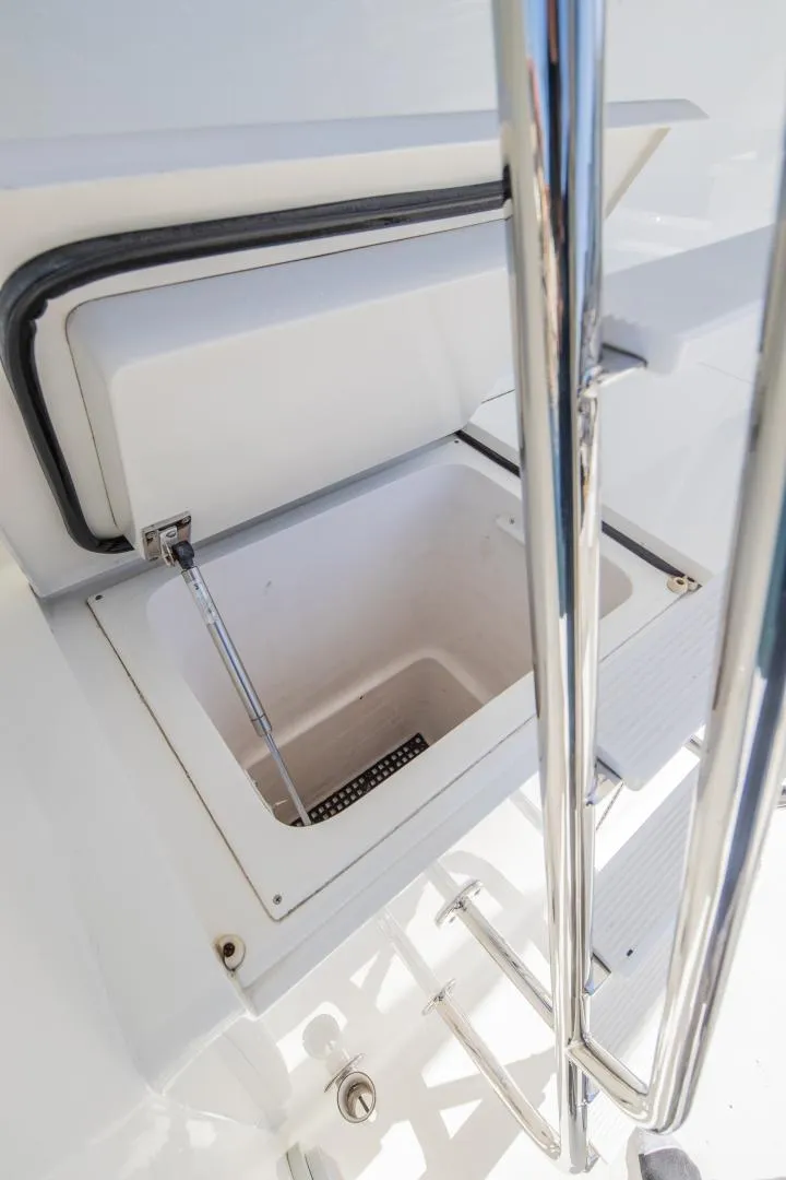 Slide: The Image of Open storage compartment on 1999 Viking 58 Enclosed Bridge yacht, featuring sleek chrome railing. - 32