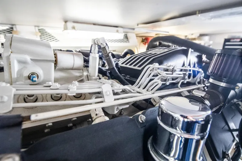 Slide: The Image of Engine room of 1999 Viking 58 Enclosed Bridge yacht, showcasing intricate mechanical components. - 35