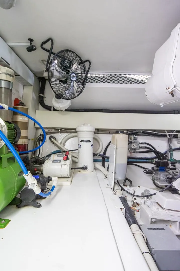 Slide: The Image of Engine room of 1999 Viking 58 Enclosed Bridge yacht with mechanical equipment and fan. - 36