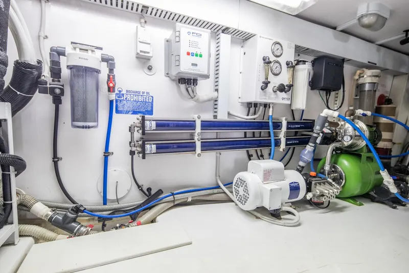 Slide: The Image of Engine room of 1999 Viking 58 Enclosed Bridge yacht with various mechanical components. - 37