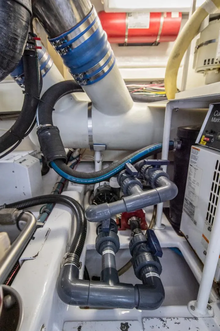 Slide: The Image of Engine room of 1999 Viking 58 Enclosed Bridge with complex piping and machinery. - 39