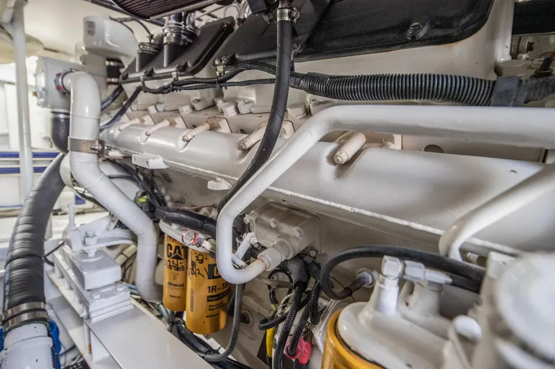 Slide: The Image of Engine room of 1999 Viking 58 Enclosed Bridge yacht, showcasing detailed machinery components. - 40