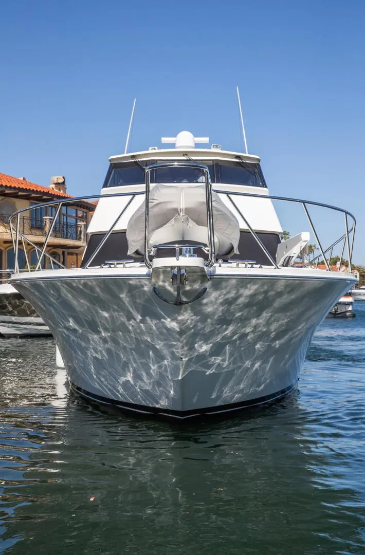 Slide: The Image of 1999 Viking 58 Enclosed Bridge yacht on water, front view, clear sky background. - 5