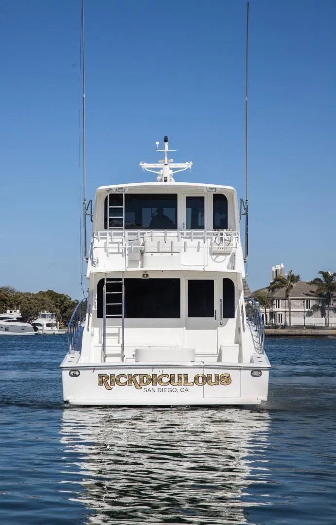 Slide: The Image of 1999 Viking 58 Enclosed Bridge yacht on calm water, rear view. - 6