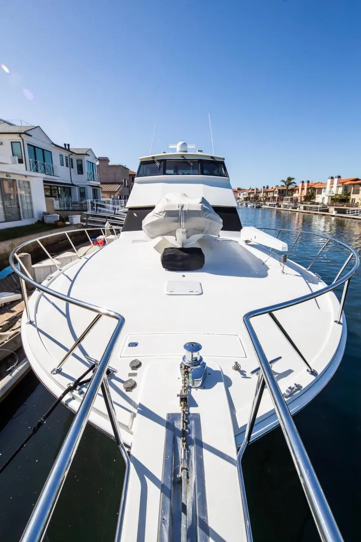 Slide: The Image of 1999 Viking 58 Enclosed Bridge yacht docked in a sunny marina. - 7