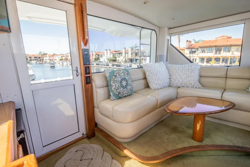 Slide: The Image of Luxurious interior of 1999 Viking 58 Enclosed Bridge yacht with plush seating and waterfront view. - 8