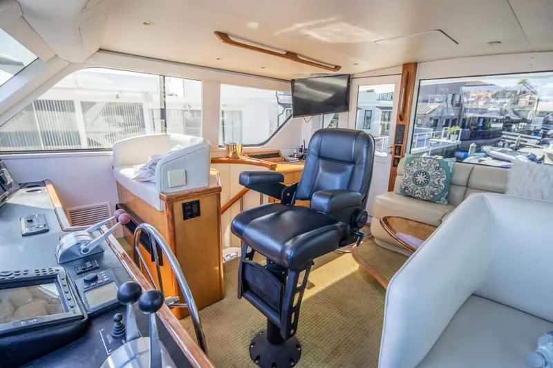 Slide: The Image of Interior of 1999 Viking 58 Enclosed Bridge yacht with helm and seating area. - 9