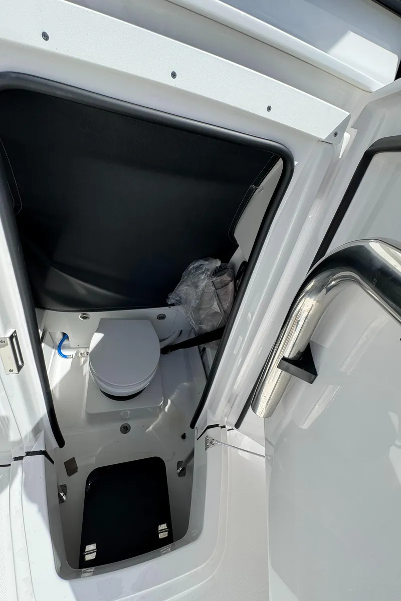 Slide: The Image of 2025 Blackfin 252 CC boat interior with compact marine toilet. - 15