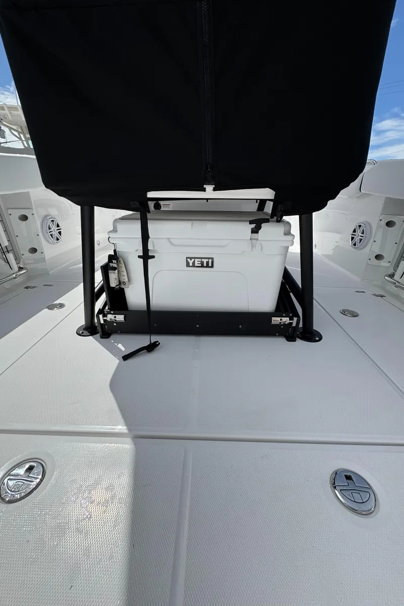Slide: The Image of 2025 Blackfin 252 CC boat deck with Yeti cooler under black cover. - 7