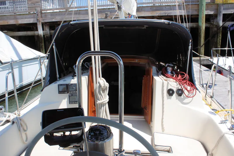 Slide: The Image of Cockpit of 2004 Pacific Seacraft 31 sailboat with navigation equipment and ropes. - 15