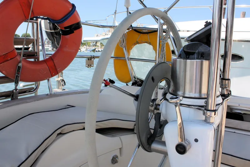 Slide: The Image of Cockpit of 2004 Pacific Seacraft 31 sailboat with steering wheel and safety equipment. - 18